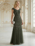 Karena Dress Juniper - Order In, elegant cap sleeve gown with sequins, fitted to thigh, in a luxurious setting.