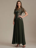 Whitney Dress Juniper Floor Length - Order In model wearing a stylish floor-length dress with intricate embellishments