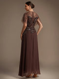 Back view of the Whitney Dress Milk Chocolate - Order In, showcasing its elegant design and floor-length silhouette.