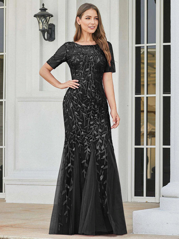 black formal dress with tulle overlay and leaf design
