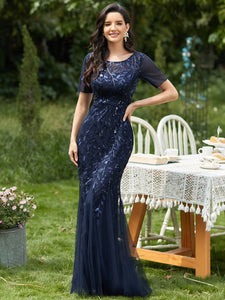 navy blue formal dress with tulle overlay and leaf design